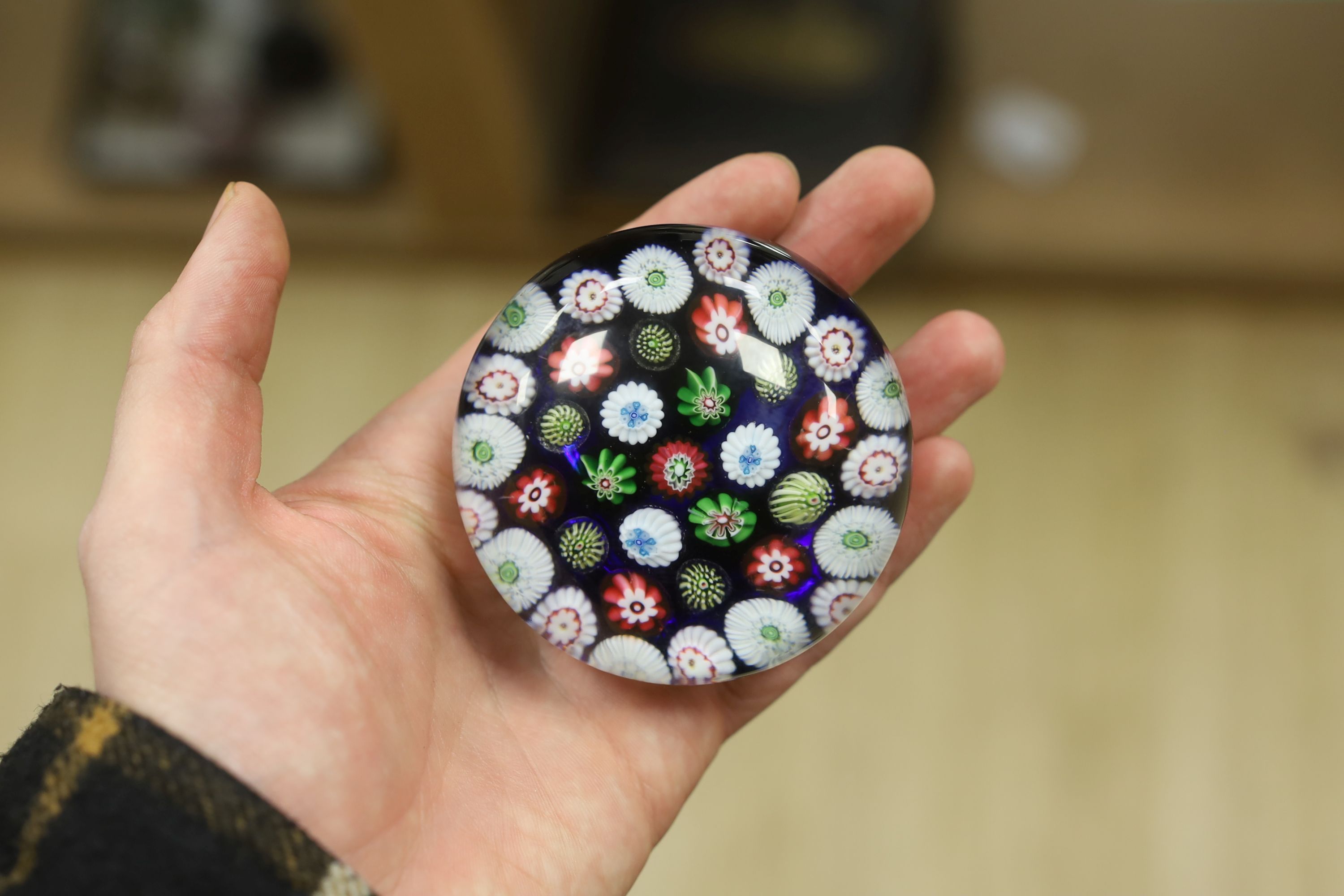 A Clichy translucent blue ground millefiori glass paperweight, 7cm in diameter